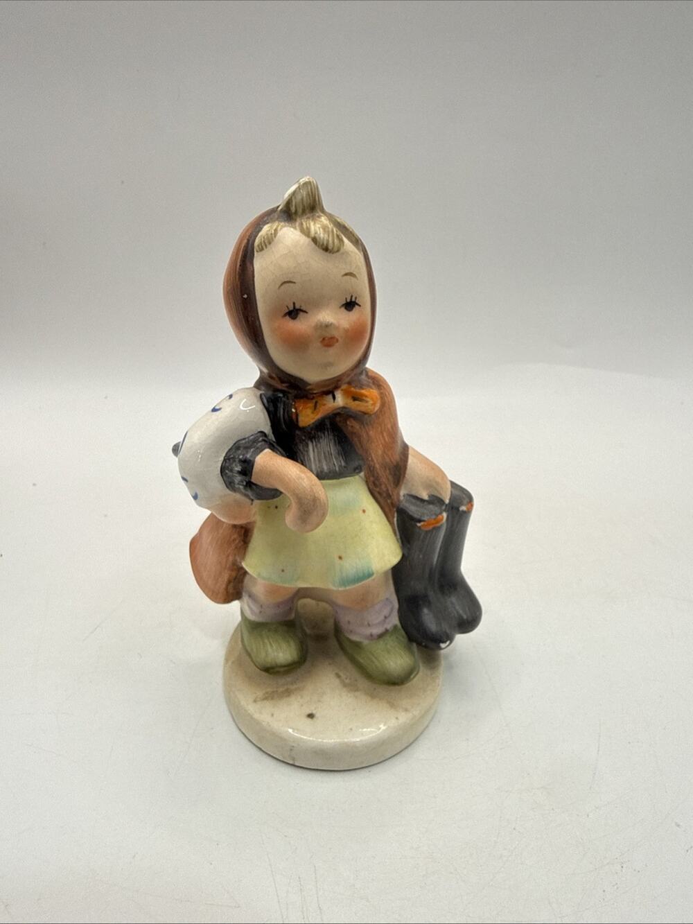 Vintage Bella Clara Girl Carrying Boots Hand Painted Ceramic Figurine 4” *